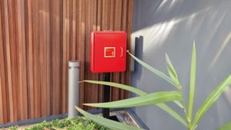 A Gerda Premises Information Box securely mounted outside a residential block for emergency access.