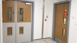 A fire doorset in a healthcare setting with appropriate fire safety signage.