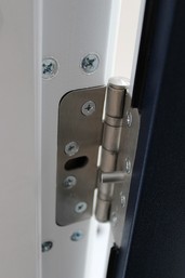 Fire safety inspector examining an internal fire door for compliance.