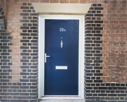 A modern external fire doorset installed in a secure residential building.