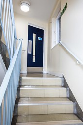 Communal fire doorset with an FD30 label, placed in a residential building hallway.