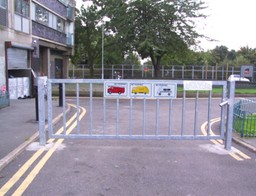 A swing gate equipped with the Gerda Barrier Gate Lock, securely closed in an outdoor setting.