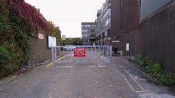 Residential complex with a vehicle barrier swing gate system controlling access to parking areas.