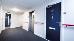 Fire doorset protecting evacuation route in multi-occupancy building