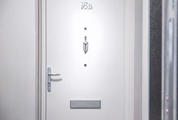 Secure and well-maintained fire doorset in a residential building corridor.